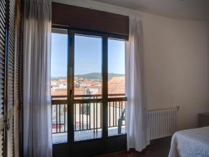 a bedroom with a large window with a view at PARAISO RIAS BAIXAS VI in Combarro
