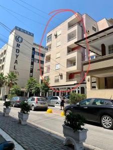 a building with a red kite in front of it at Royal apartament in Durrës