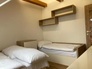 a room with two beds and shelves on the wall at Apartmány Valča in Stará Turá +194 photos