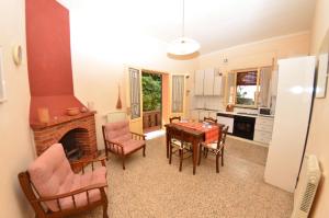 a kitchen and dining room with a table and a fireplace at Villa Elisa in Bientina