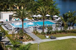 an aerial view of a resort swimming pool with palm trees at EVEN Hotel Miami - Airport by IHG in Miami