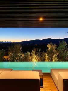 a living room with a pool with a view at C-Hotel & Spa in Cassago Brianza