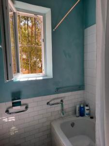 a bathroom with a bath tub and a window at Casa Inma in Miraflores de la Sierra