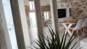 a kitchen and dining room with a table and chairs at Traditional Holiday Home in Astypalaia Town