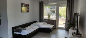 uma sala de estar com um sofá e uma janela em Casa Joda em Hügelsheim