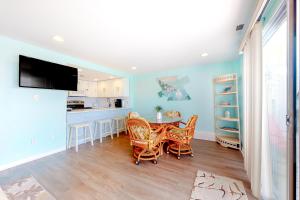 a kitchen and dining room with a table and chairs at Waves 307 in Ocean City