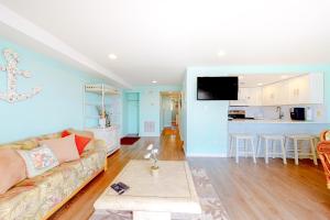 a living room and kitchen with a couch and a table at Waves 307 in Ocean City
