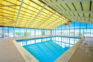 a large swimming pool in a building with windows at Waves 307 in Ocean City