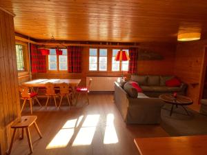 a living room with a couch and a table at Chalet Singlinaz in Zinal