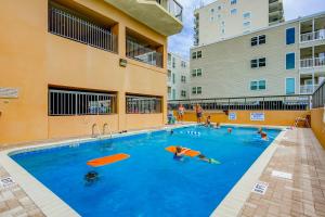 a swimming pool with people playing in the water at Wellington 304 in Myrtle Beach