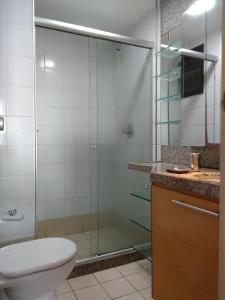 a bathroom with a shower with a toilet and a sink at Flat particular no Blue Tree Fortaleza in Fortaleza