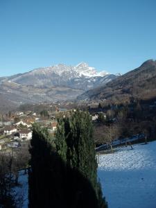 a snow covered mountain in the distance with a town at L'Eterlou Chambres d'Hote in Albertville