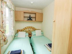 a small room with two beds in a caravan at 9 Old Orchard in Much Wenlock