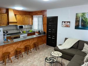 a living room with a couch and a kitchen at Casa La Orilla 2 in Playa Honda +3 photos