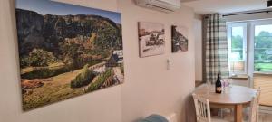 a dining room with two pictures on the wall at Neu Schweizerhaus 29 in Karpacz