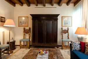 a living room with a large black cabinet and chairs at Casa Dell'Albero in Venice