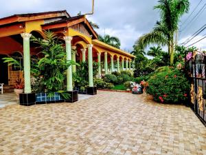 a building with a brick driveway in front of it at Chateau Margarita JA in Montego Bay