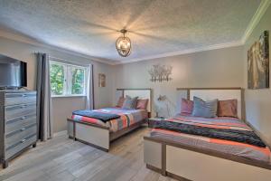 a bedroom with two beds and a dresser at Spacious Citrus Hills Home with Pool and Game Room! in Hernando +39 photos