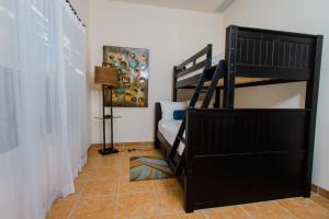 a bedroom with a bunk bed and a staircase at Puerta Cortes Residences in La Paz