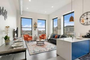 a living room with a couch and a table at Flats-King bd-Corner Unit in Newark