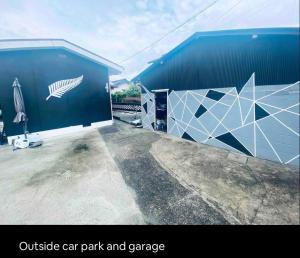 an outside car park and garage with a car park and a garage door at Da Fern in Sakaiminato