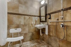 a bathroom with a toilet, sink, and bathtub at Best Western Plus Kamloops Hotel in Kamloops