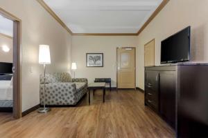 a living room filled with furniture and a tv at Best Western Plus Kamloops Hotel in Kamloops
