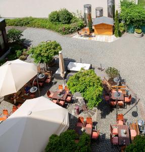 widok na patio ze stołami i parasolami w obiekcie Dorint Hotel Leipzig w Lipsku