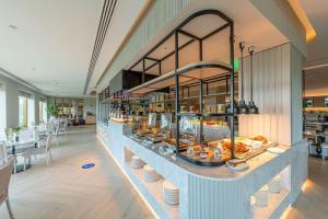 a restaurant with a buffet of food on a counter at Radisson Blu Hotel & Resort, Abu Dhabi Corniche in Abu Dhabi