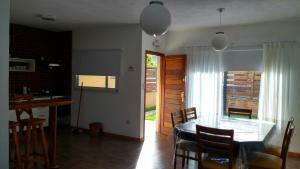 a dining room and kitchen with a table and chairs at DUPLEX TIERRA DE MAR 2 in San Clemente del Tuyú +3 photos