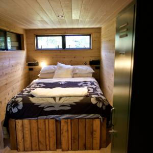 a small bedroom with a bed in a tiny house at 'ARE PEPE one bedroom container style unit in Rarotonga