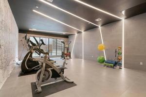 a gym with a treadmill and exercise equipment in a room at The Flats King Bed- EWR/Penn Station in Newark