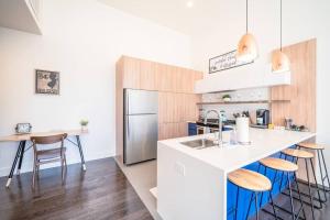 a kitchen with a white counter and a refrigerator at The Flats King Bed- EWR/Penn Station in Newark