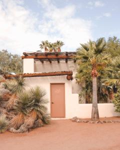 a building with a door and a palm tree at The JTH Tucson in Tucson