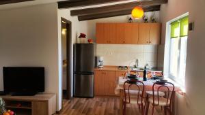a kitchen with a table and a refrigerator at Secluded holiday house Forcici, Central Istria - Sredisnja Istra - 12233 in Roč