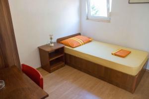 a small bedroom with a bed and a window at Holiday house with WiFi Novi Vinodolski - 12241 in Novi Vinodolski