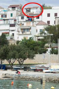a red circle is sitting on top of a building at Holiday house with WiFi Novi Vinodolski - 12241 in Novi Vinodolski