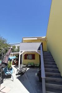 een gebouw met een patio met een veranda en een trap bij Double Room Crikvenica 12305b in Crikvenica