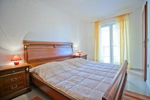 a bedroom with a large bed and a window at Apartments with a parking space Komiza, Vis - 12325 in Komiža