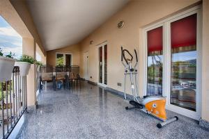 an empty room with a gym with a treadmill at Apartments with a parking space Komiza, Vis - 12325 in Komiža