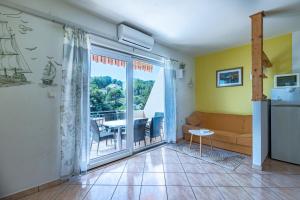 a living room with a large sliding glass door to a balcony at Apartment Basina 11923a in Vrbanj