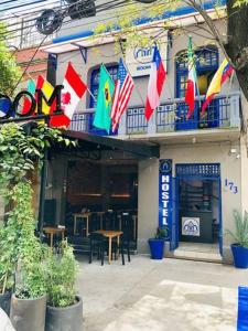 a building with flags in front of a restaurant at ROOMIES HOSTEL Roma in Mexico City