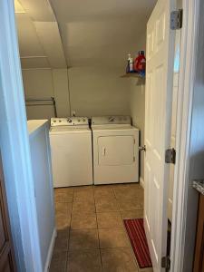 a small laundry room with a washer and dryer at Main, Three Bedroom House in Historic Loveland in Loveland