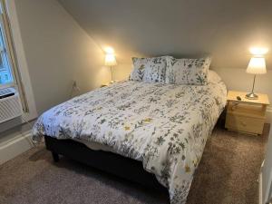 a bedroom with a bed and two lamps and a window at Main, Three Bedroom House in Historic Loveland in Loveland