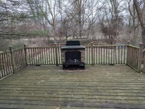 a fireplace on a wooden deck with a fence at Ohio Ave 3 bed house Historic Downtown Loveland in Loveland