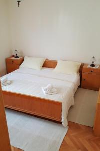 a bed with two white towels on top of it at Apartments by the sea Posedarje, Novigrad - 12402 in Posedarje
