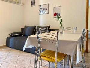 a dining room with a table and chairs with a bed at Apartments for families with children Blaskovici, Central Istria - Sredisnja Istra - 12398 in Kršan