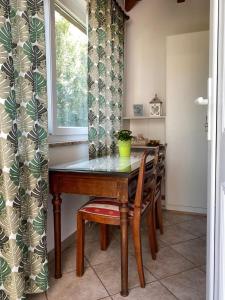 a dining room table with chairs and a window at Apartments for families with children Blaskovici, Central Istria - Sredisnja Istra - 12398 in Kršan