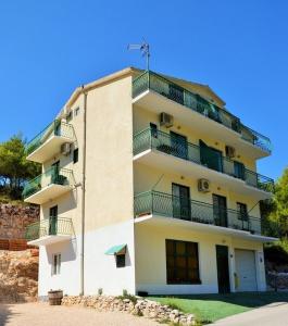 a building with balconies on the side of it at Apartments with a parking space Drvenik Donja vala, Makarska - 12297 in Drvenik