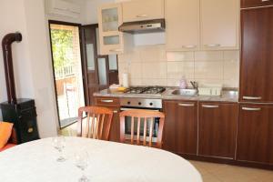 a kitchen with a table with two wine glasses on it at Apartments with parking space Basina, Hvar - 12420 in Vrbanj